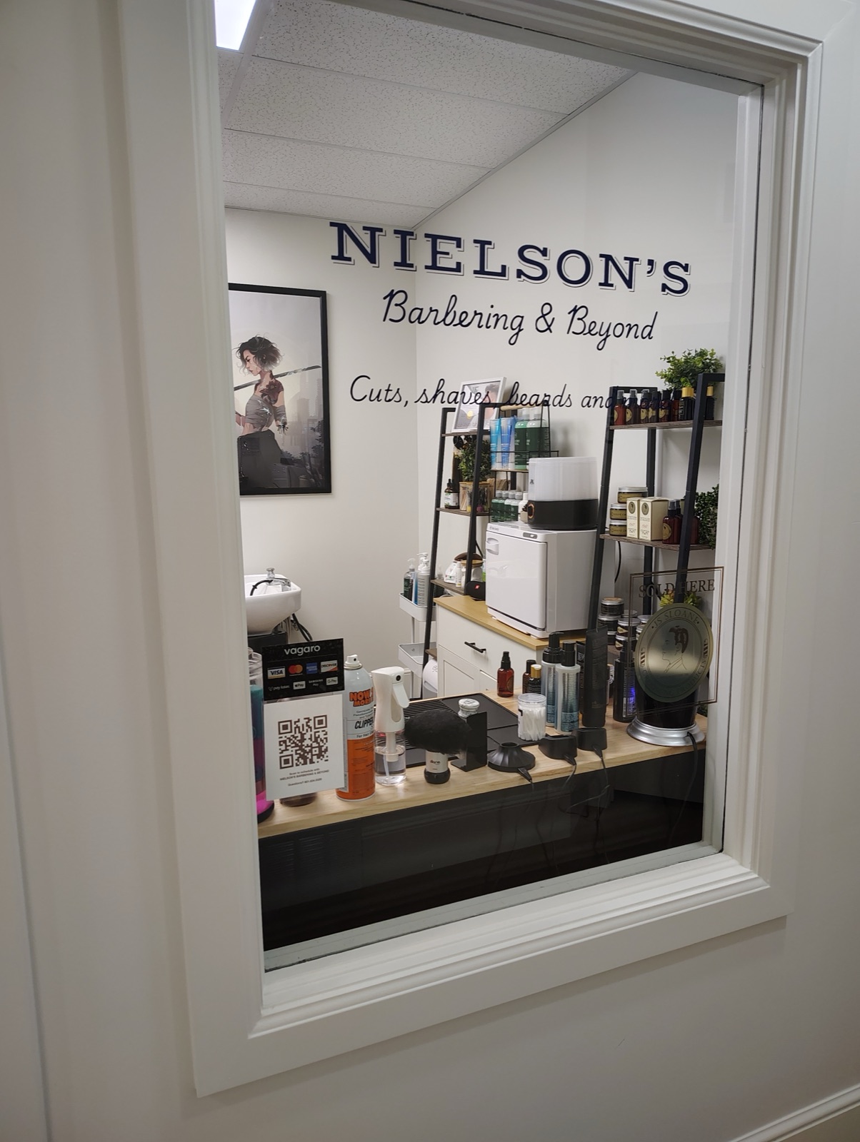 Nielson's Barbering & Beyond window sign